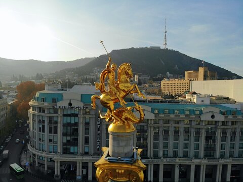 Beautiful aerial drone photography. Country Georgia from above. Capital Tbilisi. Liberty square and close up portrait of  saint George golden monument.