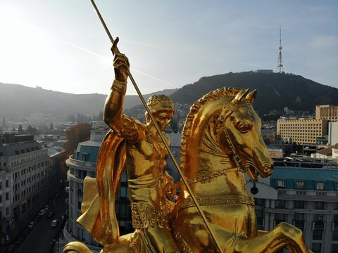Beautiful aerial drone photography. Country Georgia from above. Capital Tbilisi. Liberty square and close up portrait of  saint George golden monument.