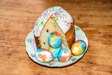 rich Easter cake and multi-colored painted eggs on a plate