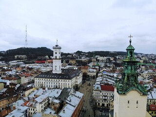 Aerial view from above of Lviv city, Ukraine. Beautiful drone photography. Main square and rooftop of city hall tower