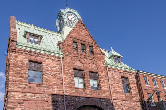 Former Almonte Post Office building red stone construction with steep gabled copper roof and central clock tower nobody