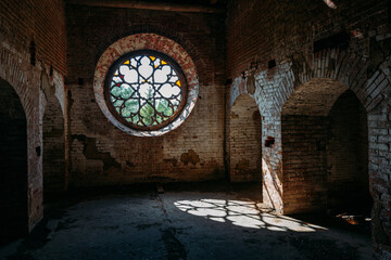 Round stained glass window in old abandoned castle