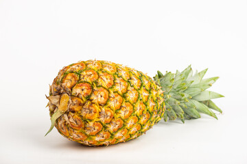whole ripe pineapple on white background