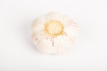 Garlic clove with shell and whole garlic on white background