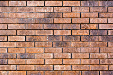 Texture of a brick or stone wall with scratches and relief. Orange, red and magenta colors. Geometric mosaic. Rectangles. Squares. Accuracy. Beautiful background with place for text.