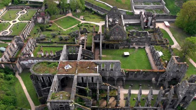 Aerial shot of old civilization ruins next to modern European road