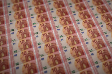 10 euro bills printed in illegal money production conveyor. Collage of many fake bills. Concept of...