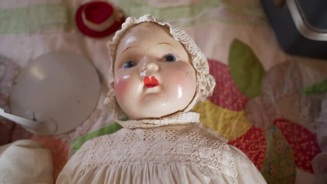 Antique toy dolls and faces stare blankly at nothing