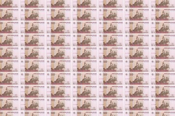 100 russian rubles bills printed in money production conveyor. Collage of many bills. Concept of...