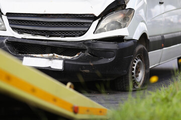 Broken minibus stands on road after an accident. Car insurance concept