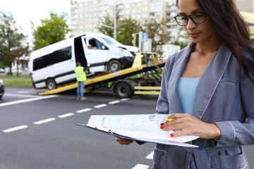 Female agent fills out insurance at the scene of accident. Services of insurance companies concept
