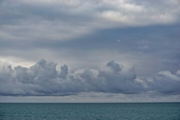 Storm clouds gathering over the deep blue waters of the Gulf of Alaska.