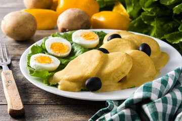 Traditional Peruvian papa a la huancaina on wooden table	