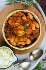 Stewed beans in tomato sauce with herbs and spices.  Top view.