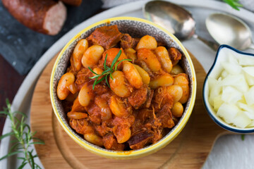Stewed beans in tomato sauce with herbs and spices.  Top view.