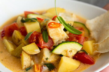 fish with vegetables and coconut sauce.