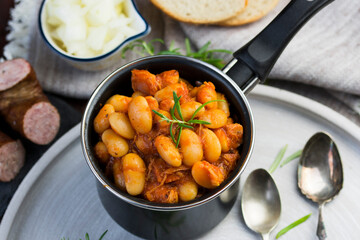Stewed beans in tomato sauce with herbs and spices.  Top view.