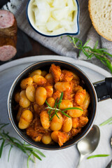 Stewed beans in tomato sauce with herbs and spices.  Top view.