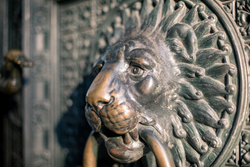 knocker Koln Cathedral, an imposing lion is the one who holds the ring