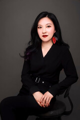 Asian mature young woman wearing black costume