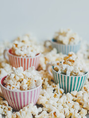 Salted popcorn in multi-colored cups