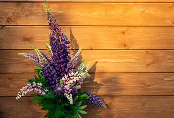 Bouquet of lupins on the background of boards