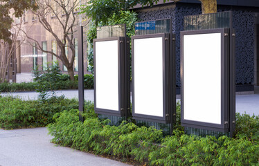 Three vertical billboards on the city streets