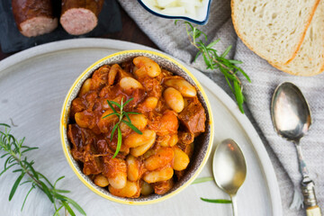 Stewed beans in tomato sauce with herbs and spices.  Top view.