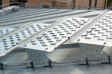 Steps of galvanized steel installed on the roof of the building,maintenance and repair of the roof.