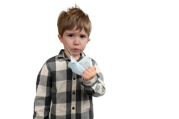 Serious little boy in a medical mask