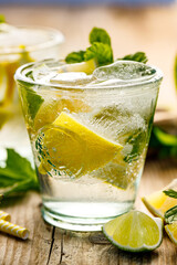Refreshing summer drink with lemons, limes and fresh mint close up view