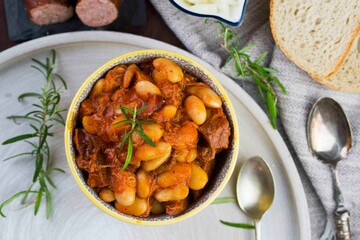 Stewed beans in tomato sauce with herbs and spices.  Top view.