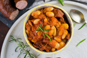 Stewed beans in tomato sauce with herbs and spices.  Top view.