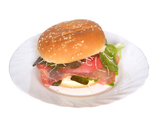 hamburger with bacon, tomato, grated cheese, lettuce and mayonnaise on a white background