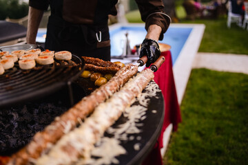 Closeup of minced kebab meat while grilling. Barbecue in the garden