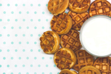 waffles with milk on a white-turquoise background copy space