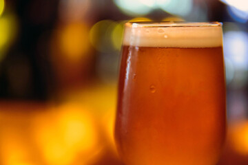 Close up of  a lager beer in a glass and blur background. Copy Space for text.