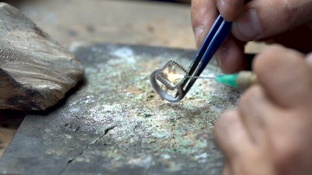 Craftsman diamond welding gold ring.Diamond ring jewelery product. Close up craftsman workshop macro shooting. hand made jewelery