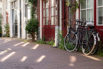 Bicycles parked near the wall of an old building