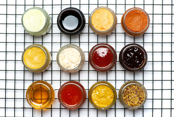 Large collection of sauces and spiced spreads in small jars