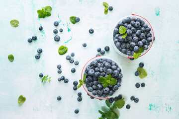Fresh raw organic blueberries in a glass container  on table. Top view, blank space