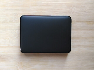 Black external hard drive kept on wooden table