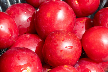 red plums with a black wooden background 