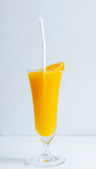 fresh orange juice in the glass with a tropical fruit slice ready for a drink