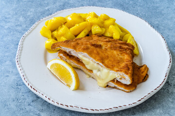 Cordon Bleu Chicken Schnitzel with Potato Salad. Half cut.
