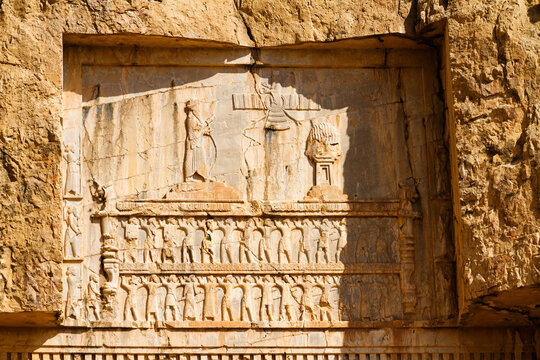 Ancient relief of the necropolis Naqsh-e Rustam that shows the triumph of Shapur I over the Roman Emperor Valerian and Philip the Arab, near ruins of Persepolis. Middle East, Asia