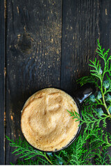cup of coffee and spruce on the table, new year mood serving size. food background top view copy space 