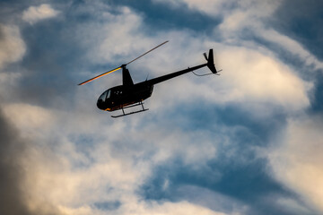 Helicopter Flying in the Evening Sky