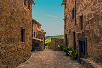 A view down a side street in the hill top settlement of Civita di Bagnoregio in Lazio, Italy in summer