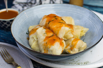 Golabki - traditional Polish food. Stuffed cabbage and tomato sauce garnished with fresh parsley.
